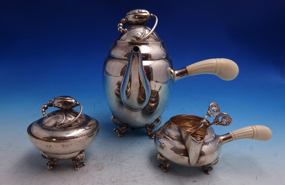 Three Piece Blossom Sterling Silver Coffee Service with Sugar Nips: Three Piece Blossom Sterling Silver Coffee Service with Sugar Nips This Georg Jensen Blossom pattern coffee set features a three-piece sterling silver collection with sugar nips, crafted in the Art No