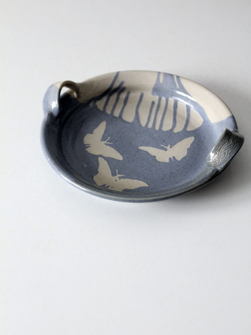 Vintage Studio Pottery Butterfly Tray with Artist Signature 9.125": Vintage Studio Pottery Butterfly Tray with Artist Signature 9.125" This charming vintage studio pottery tray features a delightful butterfly design, beautifully glazed in soft sky blue and cream. The