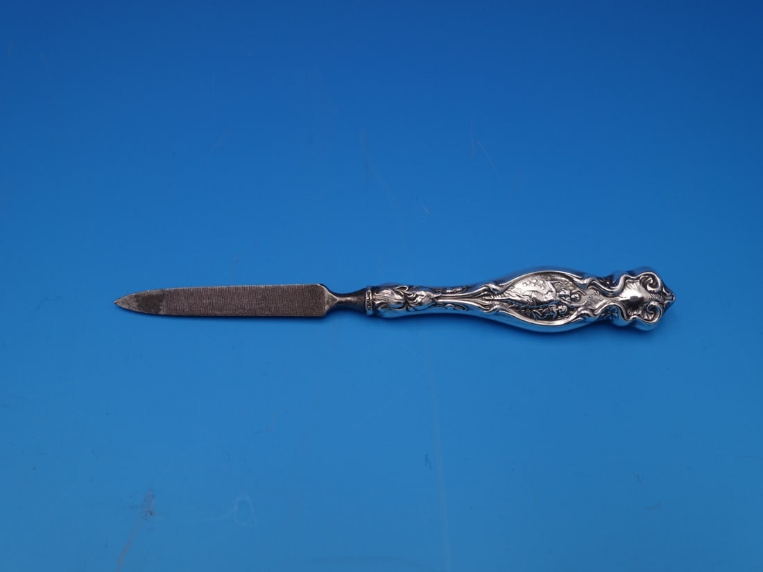 Wallace Irian Sterling Silver Vintage Nail File 6.25 inches: Wallace Irian Sterling Silver Vintage Nail File 6.25 inches This vintage Irian nail file by Wallace showcases a beautiful hollow handle crafted from sterling silver (.925). Measuring 6 1/4 inches, it