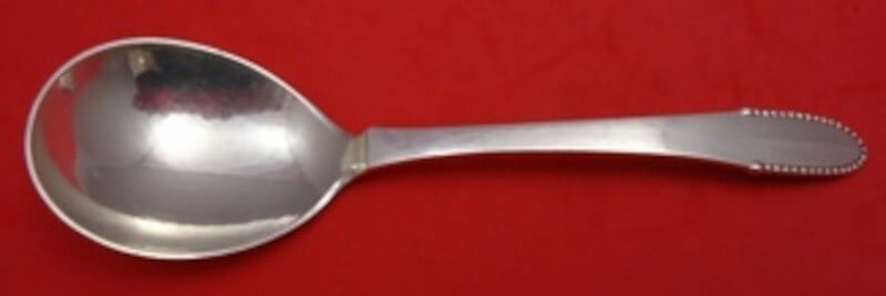 Georg Jensen Beaded Sterling Silver Ovoid Serving Spoon 6 5/8": Georg Jensen Beaded Sterling Silver Ovoid Serving Spoon 6 5/8" Introducing a stunning Sterling Silver Preserve Spoon from the renowned Beaded pattern by Georg Jensen. This elegant serving spoon, measu