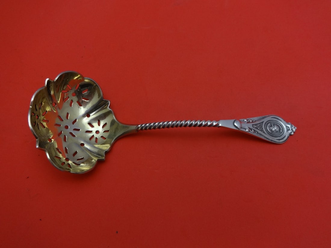 Albert Coles Medallion Sterling Silver Gold Washed Sugar Sifter Ladle 6 1/4": Albert Coles Medallion Sterling Silver Gold Washed Sugar Sifter Ladle 6 1/4" This elegant sugar sifter ladle features the Medallion pattern by Albert Coles. Crafted from fine sterling silver and enhan