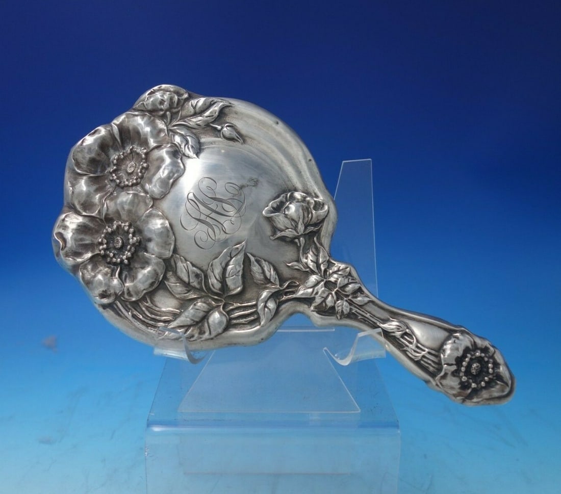 Antique Poppy Sterling Silver Mirror Frame 10.5 Inch c.1910: Antique Poppy Sterling Silver Mirror Frame 10.5 Inch c.1910 This stunning Poppy pattern sterling silver mirror frame, crafted around 1910, features an elegant design that makes it a captivating piece
