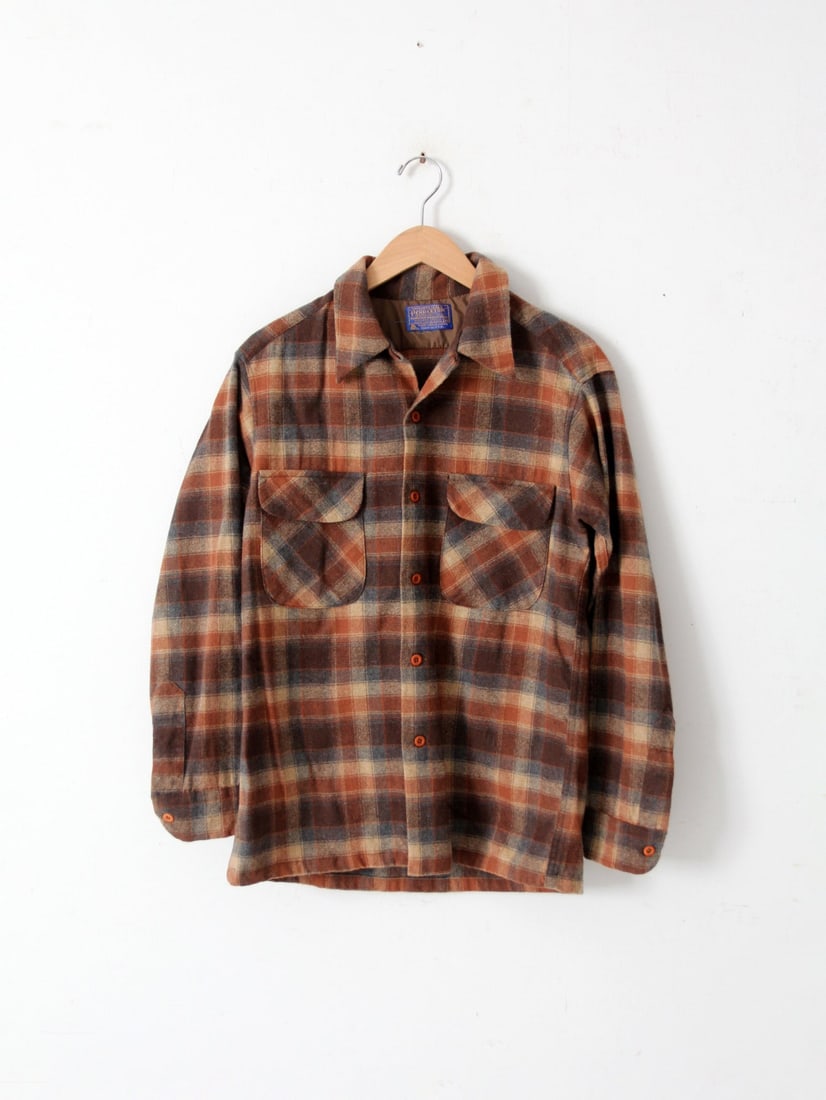 Vintage 1960s Pendleton Wool Plaid Shirt in Earthy Tones: Vintage 1960s Pendleton Wool Plaid Shirt in Earthy Tones Discover this vintage 1960's Pendleton wool button-down shirt featuring a rich plaid pattern in earthy tones of rust, charcoal grey, and beige.