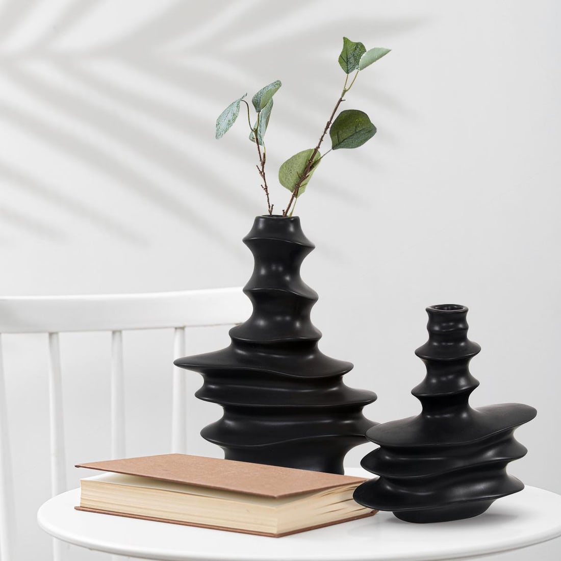 Howard Elliott Cairn Black Matte Ceramic Abstract Vase 11H 9W 3.5D: Howard Elliott Cairn Black Matte Ceramic Abstract Vase 11H 9W 3.5D This modern black matte ceramic cairn vase brings a touch of abstract elegance to any space. Crafted from high-quality ceramic, this