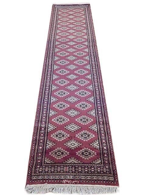 Hand-Knotted 2.6 x 10.5 Pinkish Red Jaldar Bokhara Rug: Hand-Knotted 2.6 x 10.5 Pinkish Red Jaldar Bokhara Rug Free continental US Shipping Enhance your space with this stunning 2.6 x 10.5 Pinkish Red Jaldar Bokhara Rug, a perfect blend of elegance and tra