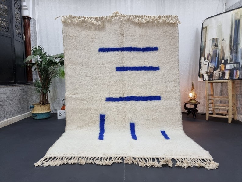Authentic Handmade Moroccan Berber Wool Rug 8x5 Feet: Authentic Handmade Moroccan Berber Wool Rug 8x5 Feet Enhance your space with this authentic soft white handmade Moroccan Berber wool rug. Each rug is meticulously handwoven in the Atlas Mountains by s