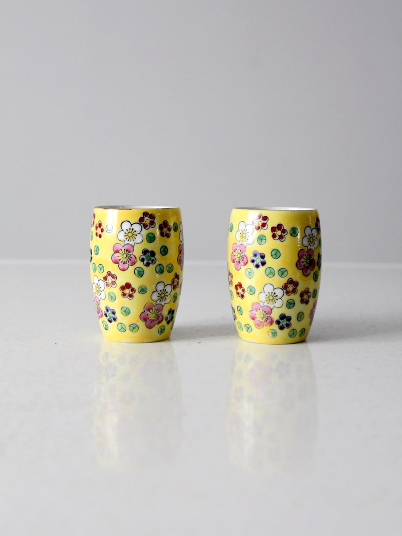 Pair of Vintage Floral Pottery Vases with Hand-Painted Design by Viking: Pair of Vintage Floral Pottery Vases with Hand-Painted Design by Viking This mid-century pair of Viking hand-painted pottery vases features a lively floral pattern on a warm yellow glaze. The compact