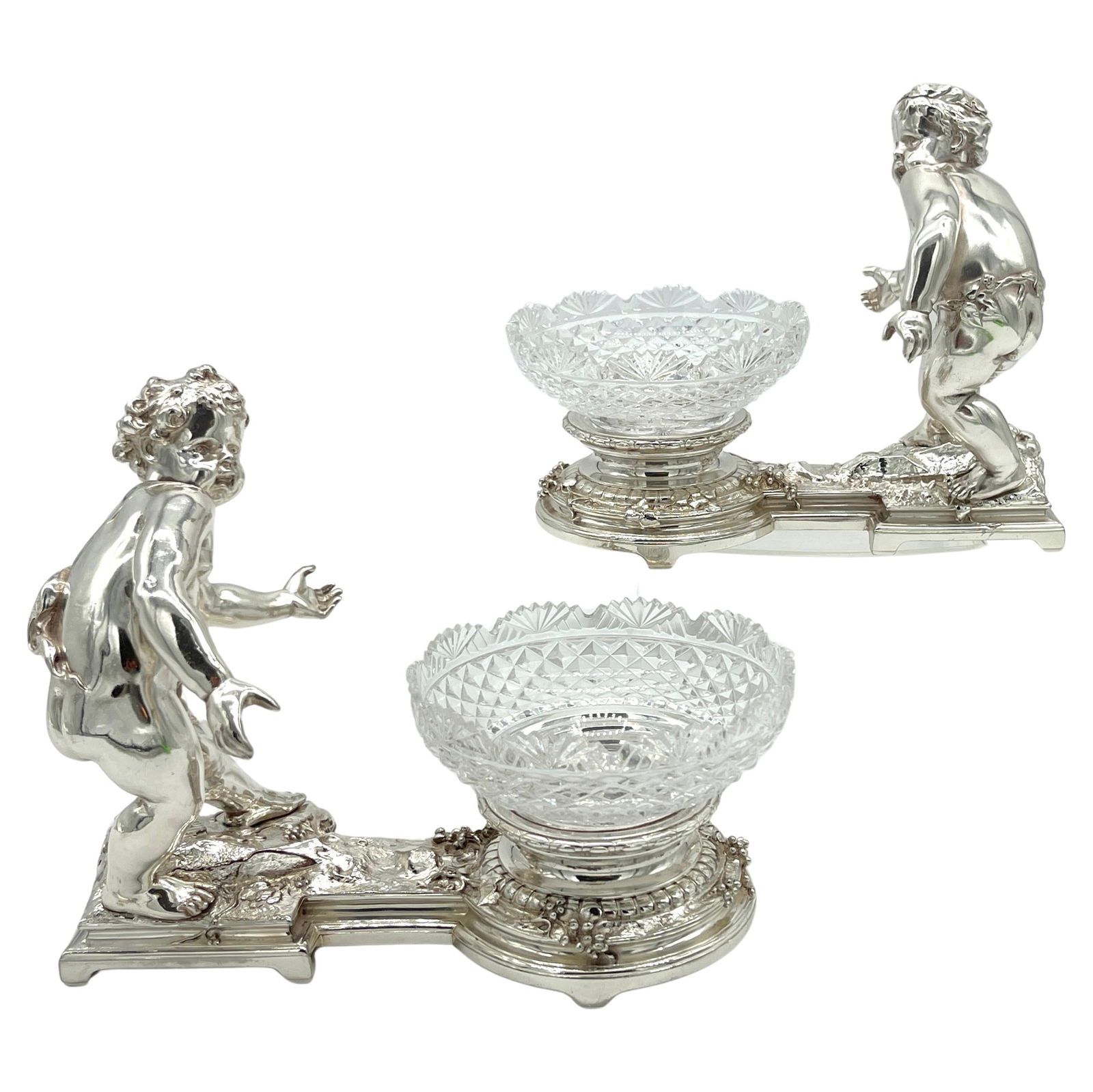 19th Century Christofle Silvered Bronze Putti Crystal Centerpieces Set of 2: 19th Century Christofle Silvered Bronze Putti Crystal Centerpieces Set of 2 This exquisite pair of 19th-century Christofle silvered bronze putti and crystal centerpieces exemplifies the exceptional cr