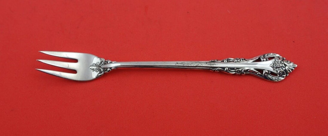 International Sterling Silver Masterpiece Cocktail Fork 5.5": International Sterling Silver Masterpiece Cocktail Fork 5.5" This elegant cocktail fork from the Masterpiece pattern by International Sterling is crafted in sterling silver, measuring 5 1/2" in length