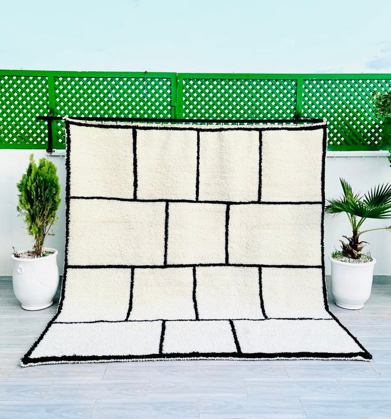 Authentic Handmade Moroccan Berber Wool Rug 3.28 x 5 ft: Authentic Handmade Moroccan Berber Wool Rug 3.28 x 5 ft Enhance your space with this exquisite small authentic handmade Moroccan Berber wool rug. Featuring a striking black geometric pattern, this rug