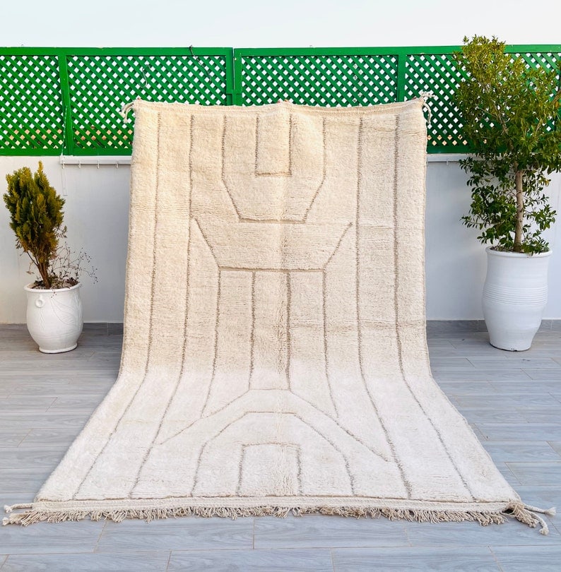 Authentic Moroccan Berber Wool Rug with Engraved Pattern 9.84 x 6.56 Feet: Authentic Moroccan Berber Wool Rug with Engraved Pattern 9.84 x 6.56 Feet Discover the elegance of this Authentic Handmade Moroccan Berber Wool Rug, featuring a unique engraved geometric pattern. Each
