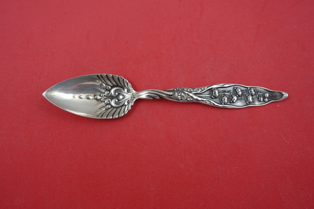 Whiting Sterling Silver Lily of the Valley Grapefruit Spoon 5.5 Wide Handle: Whiting Sterling Silver Lily of the Valley Grapefruit Spoon 5.5 Wide Handle This exquisite grapefruit spoon features the "Lily of the Valley" pattern by Whiting, crafted from high-quality sterling sil