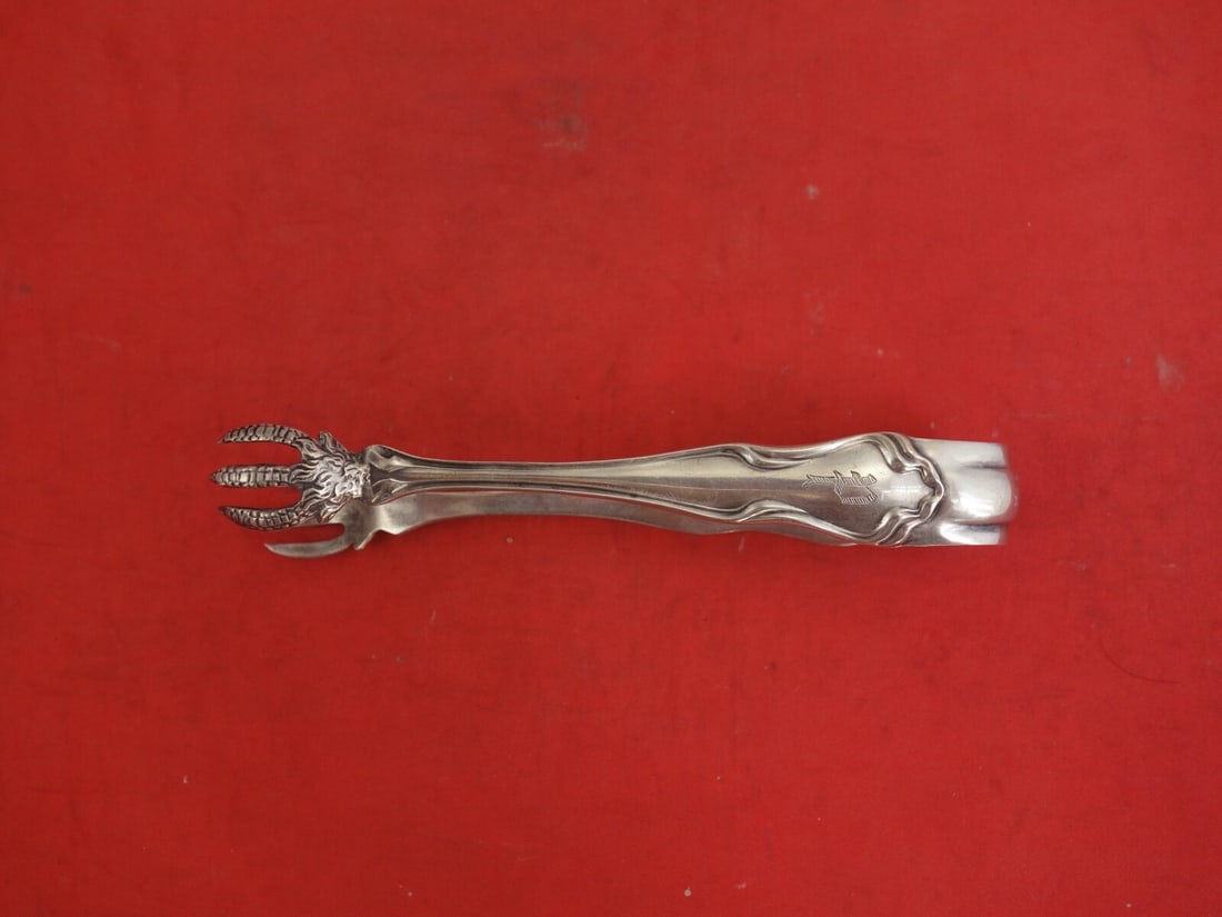 Shiebler Wave Sterling Silver Sugar Tong 4.5 Inch Serving Piece: Shiebler Wave Sterling Silver Sugar Tong 4.5 Inch Serving Piece Enhance your serving experience with the Wave by Shiebler Sterling Silver Sugar Tong, measuring 4 1/2". This exquisite piece features th