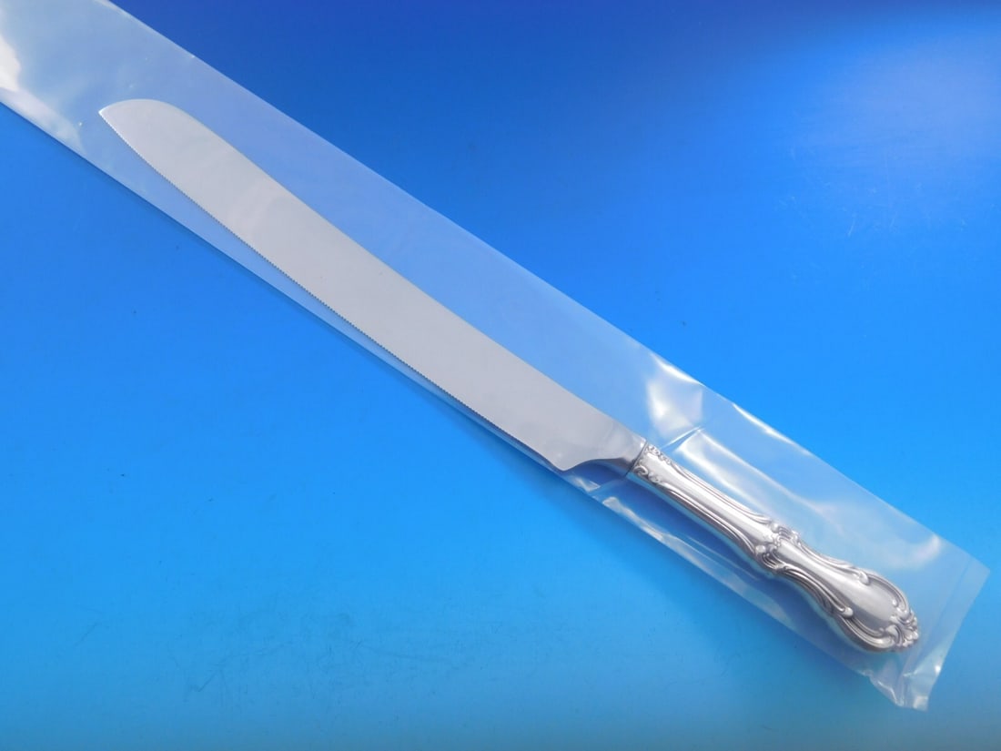 Joan of Arc Sterling Silver Wedding Cake Knife 12" by International Silver: Joan of Arc Sterling Silver Wedding Cake Knife 12" by International Silver This exquisite wedding cake knife features the elegant "Joan of Arc" pattern by International Sterling. Crafted with a sterli