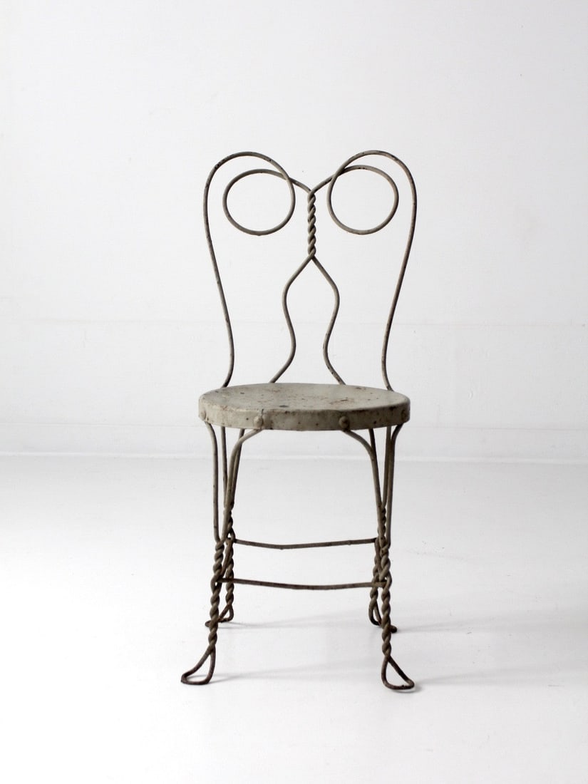 Vintage Gray Metal Ice Cream Parlor Chair with Curved Design: Vintage Gray Metal Ice Cream Parlor Chair with Curved Design This vintage gray ice cream parlor chair features a classic cafe design crafted from metal, showcasing a twisting, curved shape with a meta