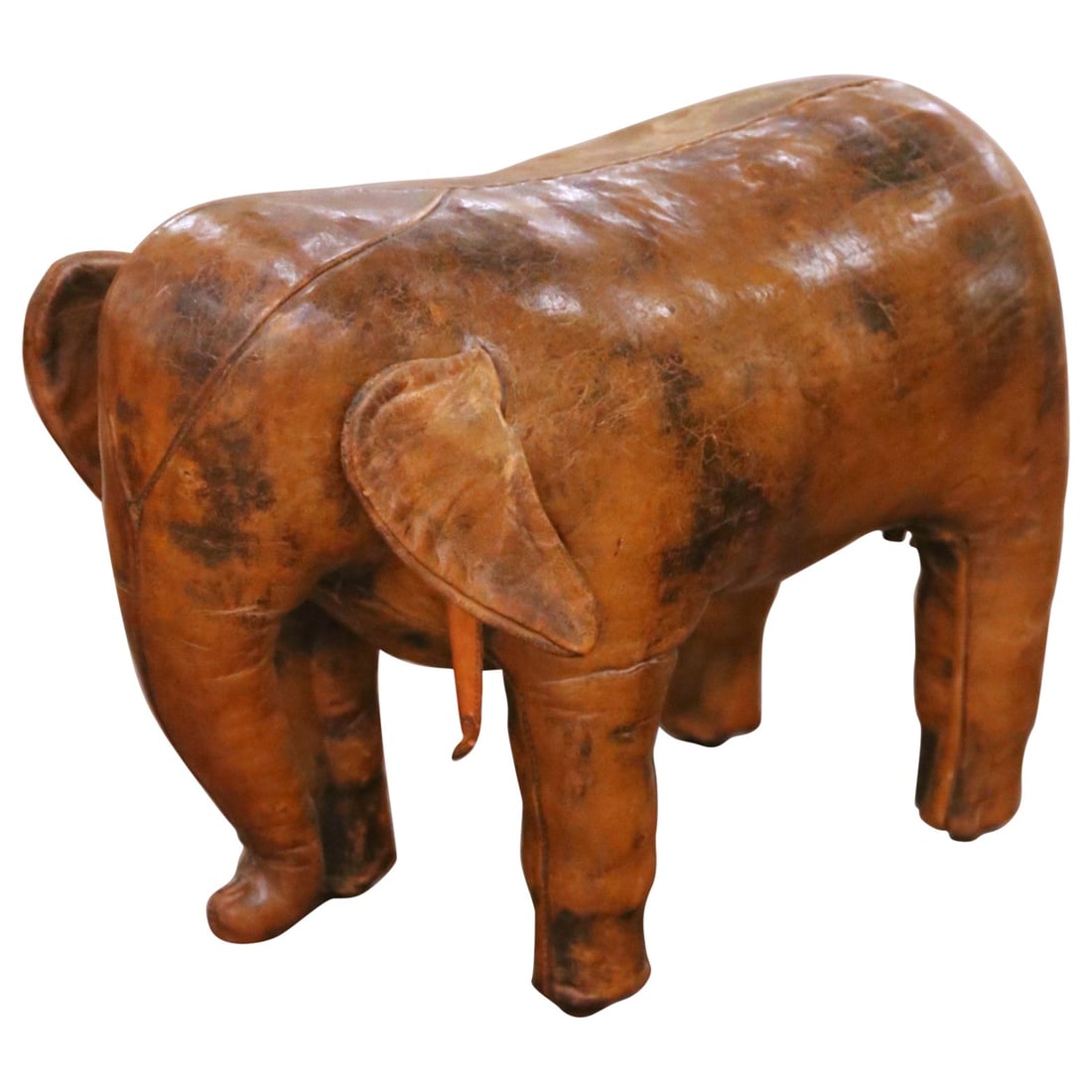 Handcrafted Spanish Leather Elephant Footstool with Patina Circa 1970: Handcrafted Spanish Leather Elephant Footstool with Patina Circa 1970 This vintage footstool, crafted in Spain circa 1970, is designed in the shape of a stylized elephant and upholstered in original b