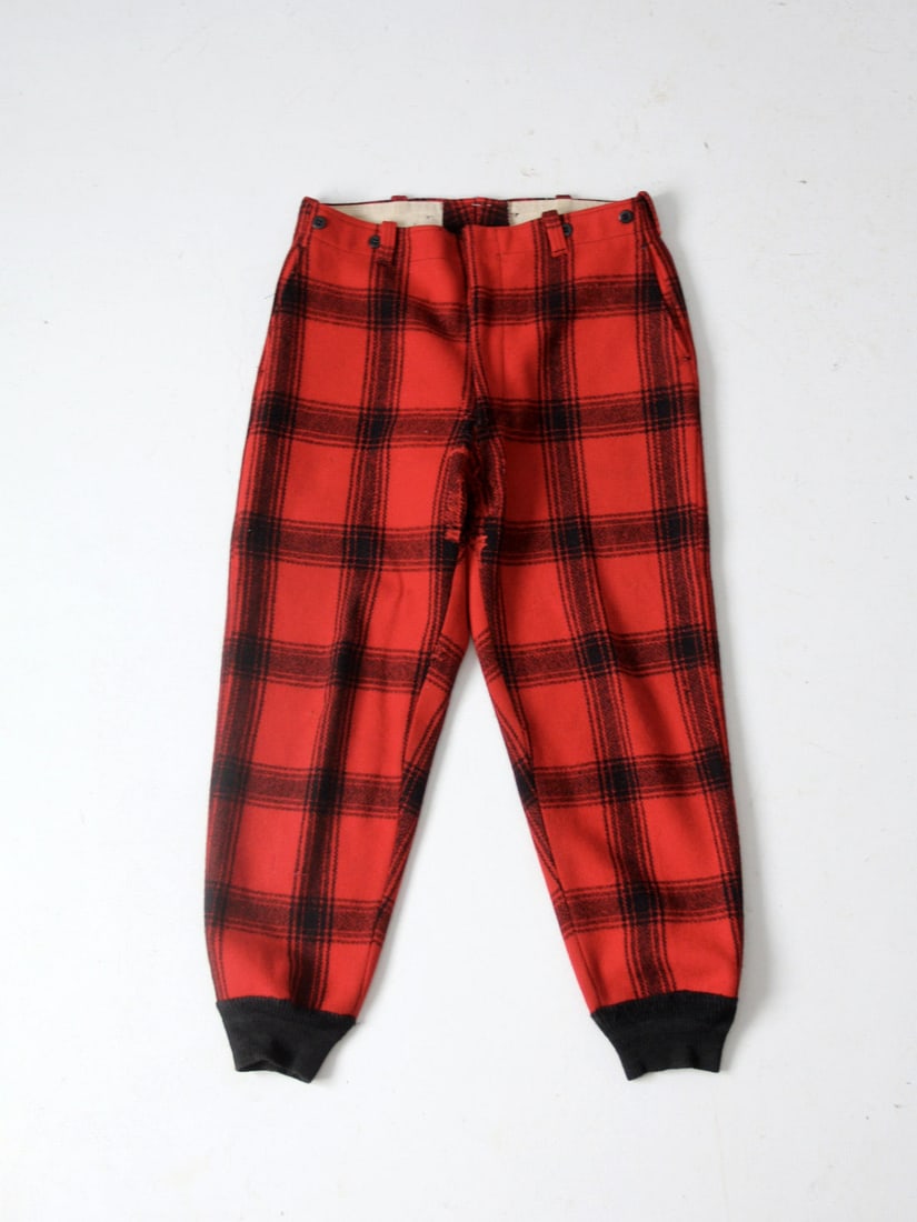 1960s Vintage Red Black Plaid Wool Hunting Pants L: 1960s Vintage Red Black Plaid Wool Hunting Pants L Discover a pair of vintage plaid wool hunting pants from the 1960s, featuring a striking red and black plaid design. Crafted from heavy cut wool, the