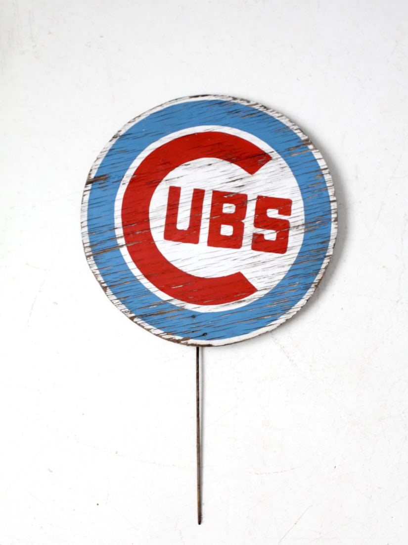 Vintage Cubs Round Wood Sign with Iron Stake 16 Inch: Vintage Cubs Round Wood Sign with Iron Stake 16 Inch This vintage hand-painted Cubs sign showcases the classic red, white, and blue emblem on a round wood plaque, embodying the spirit of Chicago baseb