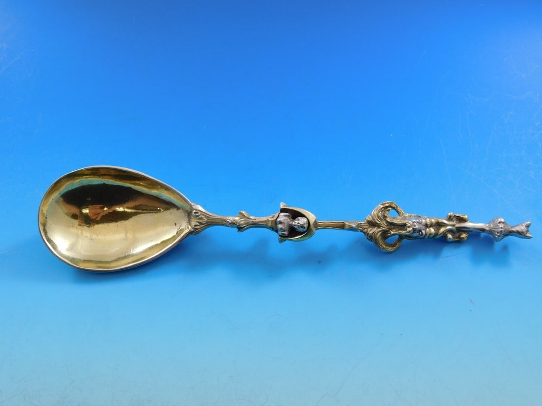 European Sterling Silver Vermeil Preserve Spoon with Figural Heads 8 1/8": European Sterling Silver Vermeil Preserve Spoon with Figural Heads 8 1/8" This exquisite European sterling silver preserve spoon features a heavy cast design adorned with four intricately detailed fig