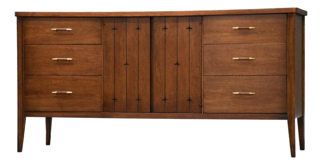 Mid Century Walnut Nine Drawer Dresser with Star Motifs by Saga: Mid Century Walnut Nine Drawer Dresser with Star Motifs by Saga This mid-century modern dresser by Broyhill Saga features a classic walnut construction with nine drawers, two doors, and etched star de