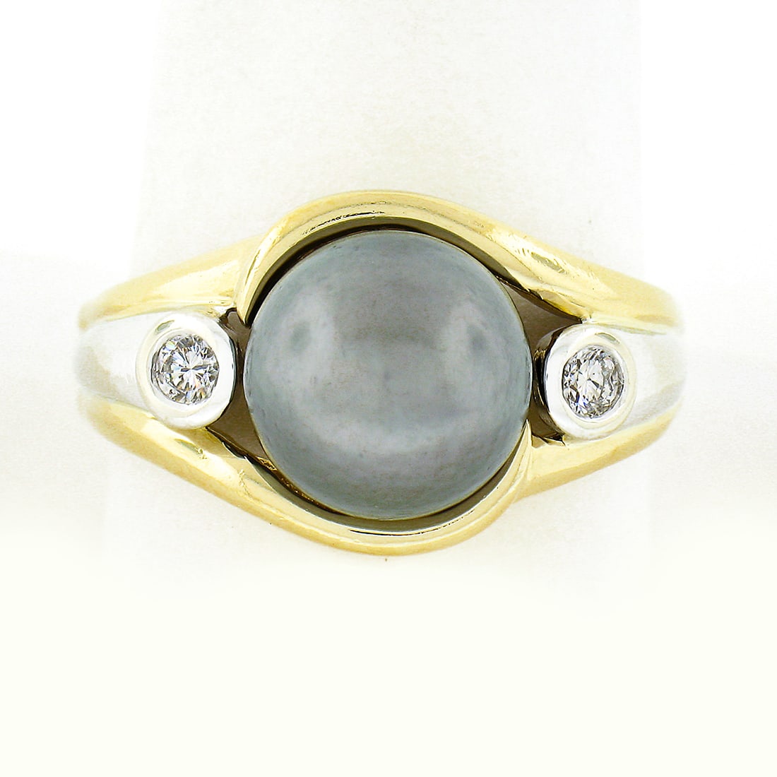 14K Two Tone Gold 10.1mm Dark Gray Tahitian Pearl Diamond 3 Stone Ring: 14K Two Tone Gold 10.1mm Dark Gray Tahitian Pearl Diamond 3 Stone Ring This exquisite ring features a stunning 10.1mm dark gray Tahitian pearl securely set in a three-stone design. Crafted from solid