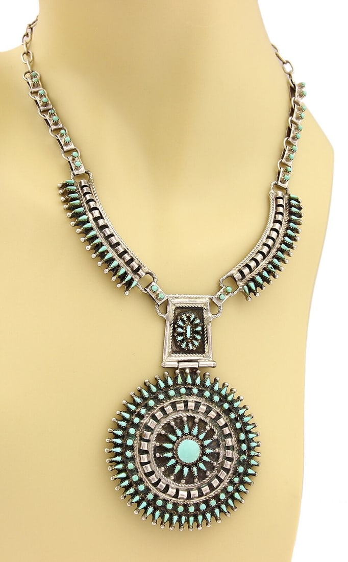 Lariat Necklace with Large Turquoise Medallion in Sterling Silver: Lariat Necklace with Large Turquoise Medallion in Sterling Silver This vintage lariat necklace features a large round turquoise medallion set in sterling silver. The intricate design and substantial s