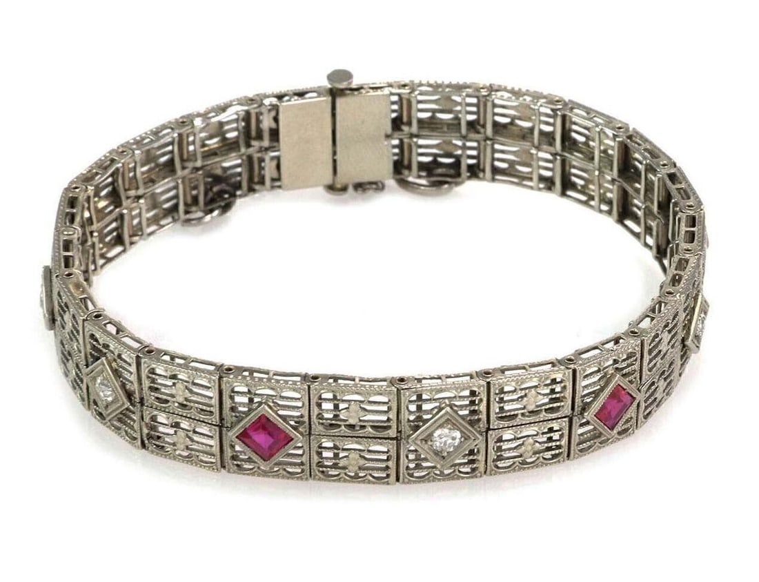 Vintage 18k White Gold Art Deco Filigree Bracelet with Diamonds and Synthetic Rubies: Vintage 18k White Gold Art Deco Filigree Bracelet with Diamonds and Synthetic Rubies This vintage Art Deco bracelet is crafted from solid 18k white gold, featuring intricate filigree and milgrain deta