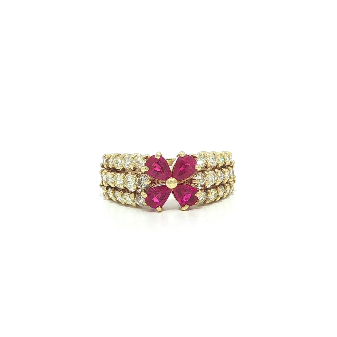 Band Ring with Pear Ruby and Diamond Accents in 18k Yellow Gold: Band Ring with Pear Ruby and Diamond Accents in 18k Yellow Gold This band ring features four pear brilliant cut natural rubies in vivid red, totaling 0.83 carats, and thirty round brilliant cut natura