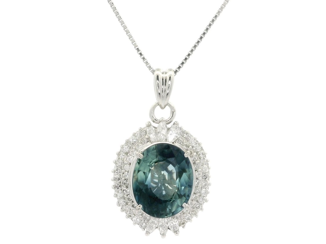 Platinum GIA Certified 5.89ct Oval Blue Sapphire Diamond Halo Pendant Necklace: Platinum GIA Certified 5.89ct Oval Blue Sapphire Diamond Halo Pendant Necklace This stunning pendant necklace features a large oval sapphire of 5.12 carats, showcasing a gorgeous multi-shade blue colo