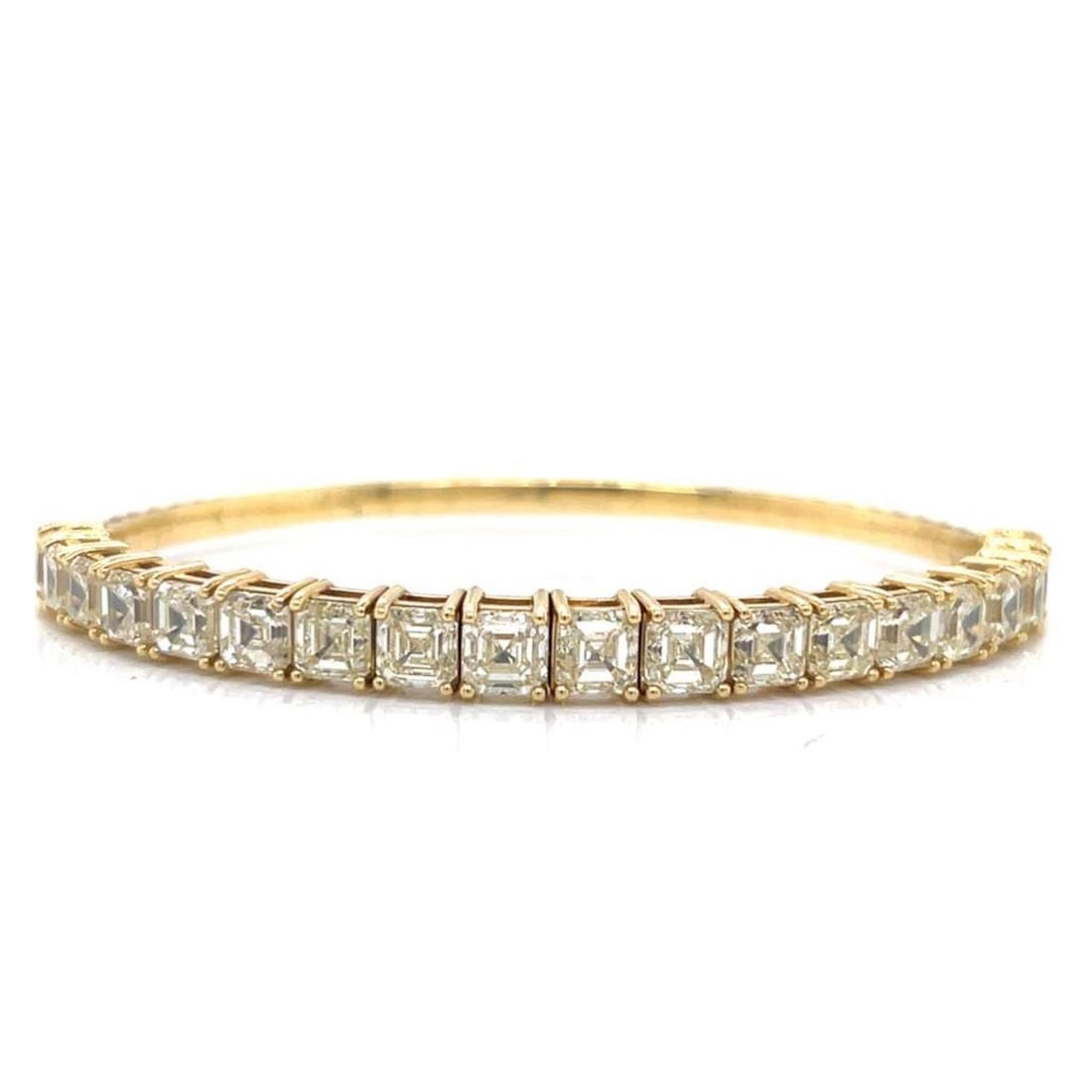 10.00 Carat Ascher Cut Diamond Bangle in 18K Yellow Gold: 10.00 Carat Ascher Cut Diamond Bangle in 18K Yellow Gold This elegant bangle is crafted from 18K yellow gold and features 19 Ascher-cut diamonds with a total approximate weight of 10.00 carats. The di