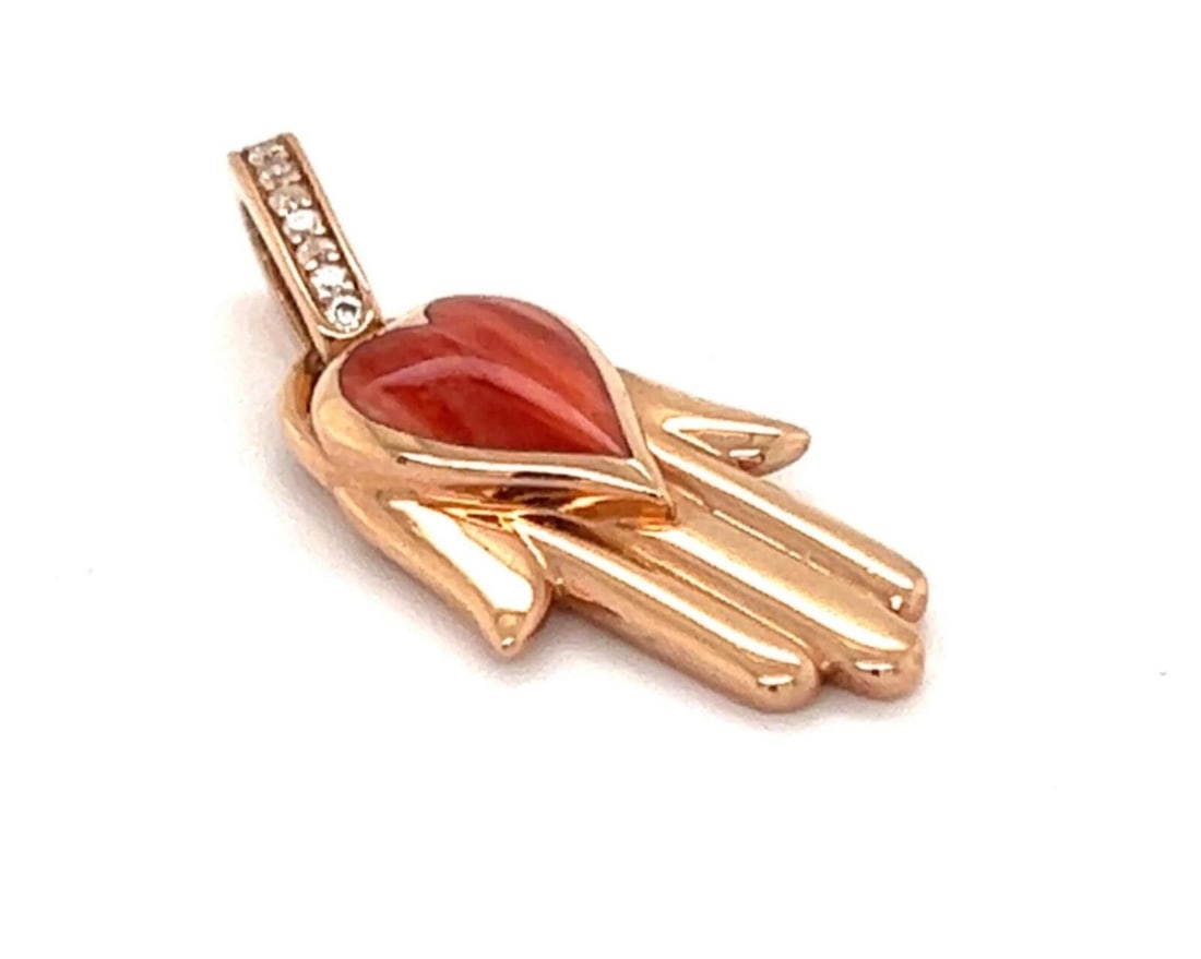14k Rose Gold Hamsa Pendant with Diamond and Orange Oyster by Kabana: 14k Rose Gold Hamsa Pendant with Diamond and Orange Oyster by Kabana This Kabana pendant is crafted from 14k rose gold and features a hand hamsa Fatima charm adorned with a diamond and orange spiny oy