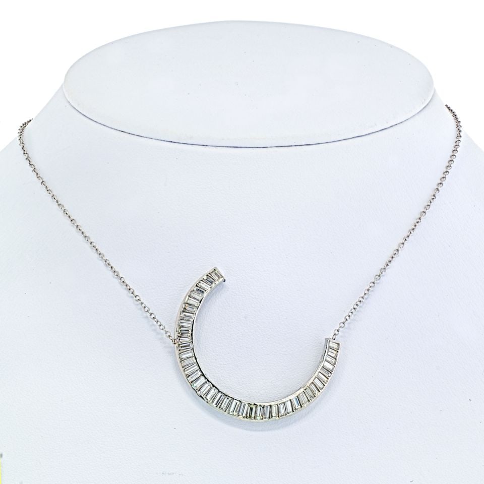Vintage Platinum Crescent Pendant with 3.5ct Baguette Diamonds: Vintage Platinum Crescent Pendant with 3.5ct Baguette Diamonds This exquisite vintage crescent pendant is beautifully crafted in platinum and features a stunning arrangement of baguette diamonds total
