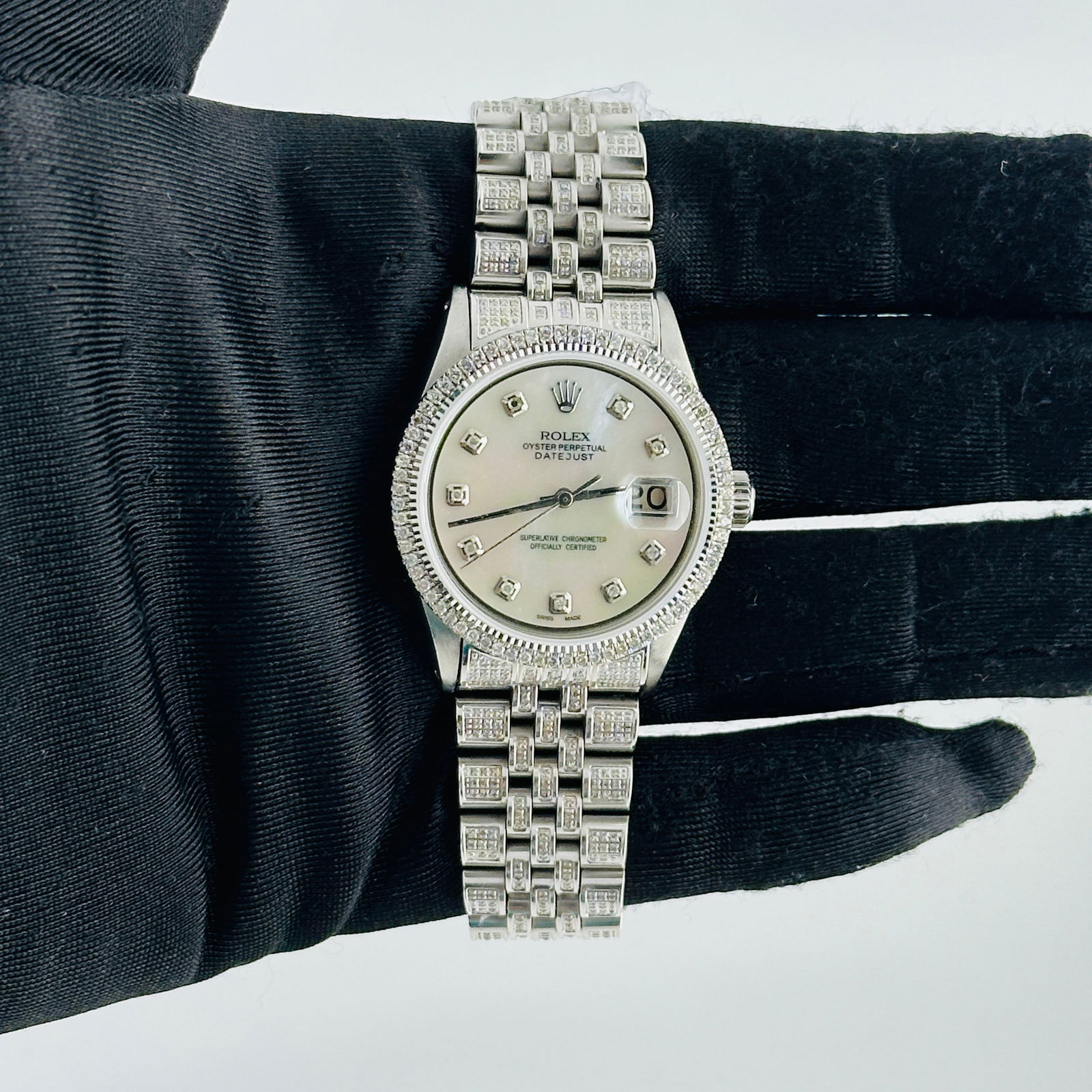Datejust Ref 1601 Men's Watch With Aftermarket Diamond MOP Dial and Iced Out Jubilee: Datejust Ref 1601 Men's Watch With Aftermarket Diamond MOP Dial and Iced Out Jubilee This is a men's Rolex Datejust watch, reference number 1601. It features an aftermarket white mother of pearl dial