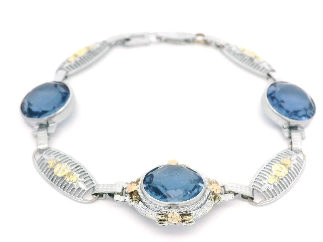Unbranded 8k-10k White Green Rose Gold Floral Link Bracelet with Blue Stones: Unbranded 8k-10k White Green Rose Gold Floral Link Bracelet with Blue Stones This exquisite link bracelet features a delicate floral filigree design, masterfully crafted in solid white, green, and ros