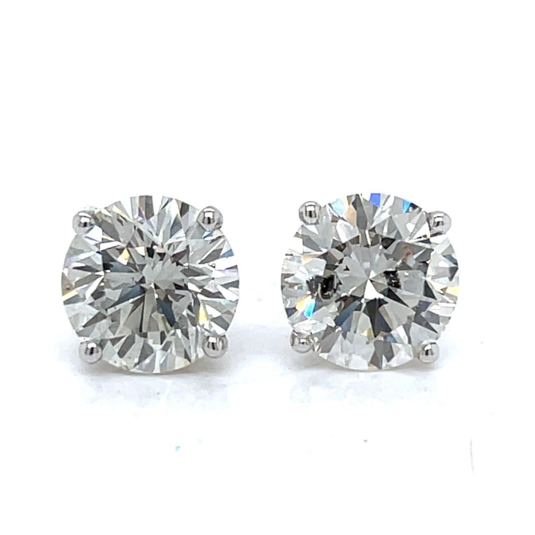 GIA Certified 5.43 Ct Diamond Studs in 14K White Gold: GIA Certified 5.43 Ct Diamond Studs in 14K White Gold These stud earrings feature two diamonds with a combined total weight of 5.43 carats, set in 14K white gold. One earring is set with a GIA certifi
