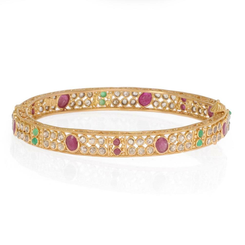 Vintage 22k Gold Filigree Bangle with Diamonds Rubies Emeralds: Vintage 22k Gold Filigree Bangle with Diamonds Rubies Emeralds Adorn your wrist with this exquisite vintage bangle featuring a captivating migraine design. Crafted from luxurious 22k yellow gold, this