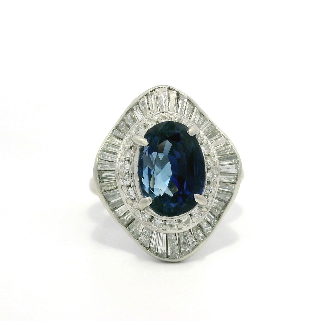 Vintage Platinum GIA Certified 5.41ct Blue Sapphire Diamond Halo Ring: Vintage Platinum GIA Certified 5.41ct Blue Sapphire Diamond Halo Ring This exquisite vintage ballerina ring showcases a stunning 4.32ct natural oval sapphire, characterized by its royal blue color and