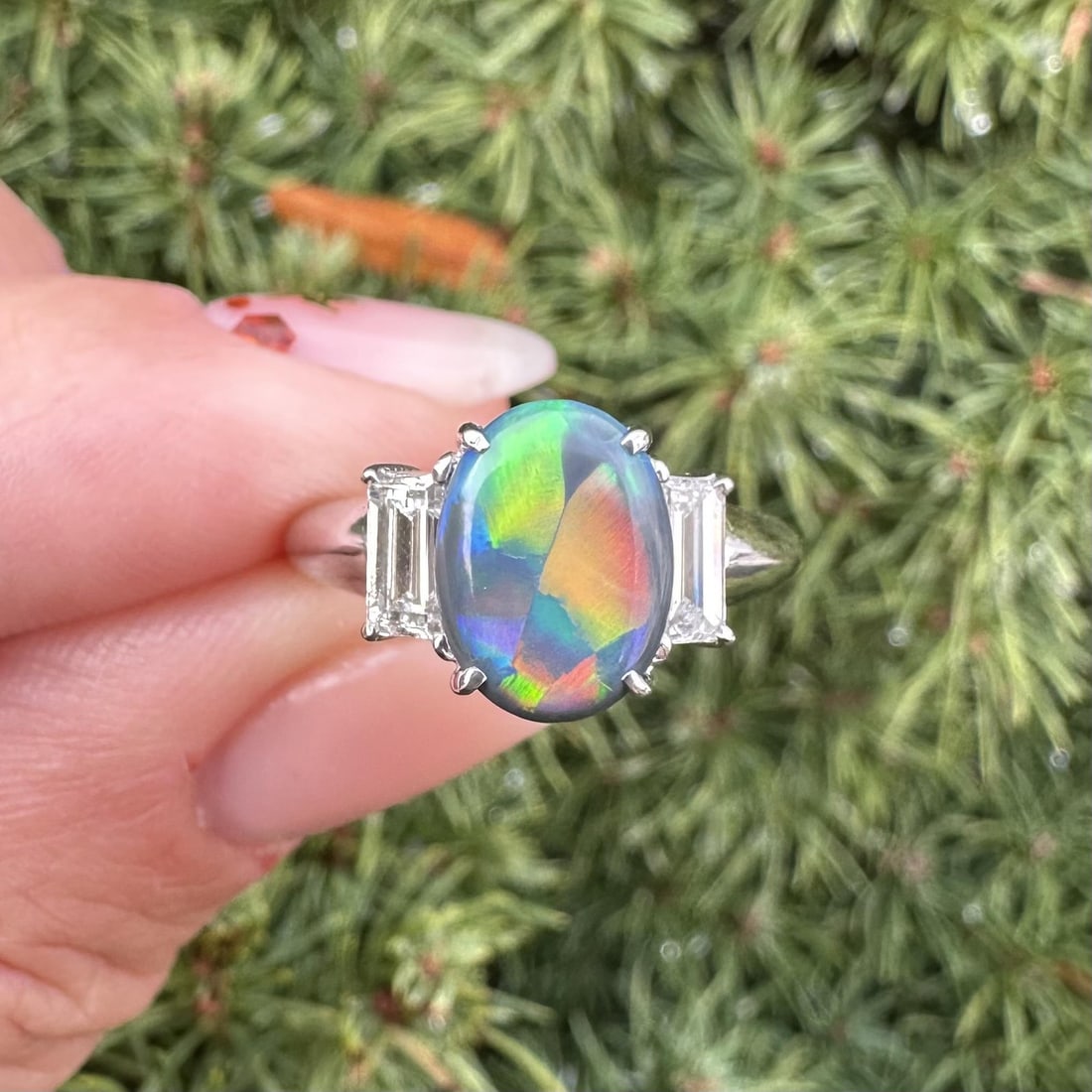 Platinum GIA Certified 2.33ct Black Opal Baguette Diamond Cocktail Ring: Platinum GIA Certified 2.33ct Black Opal Baguette Diamond Cocktail Ring This stunning cocktail ring showcases a breathtaking natural black opal in a double cabochon cut, weighing 1.66 carats, set in s