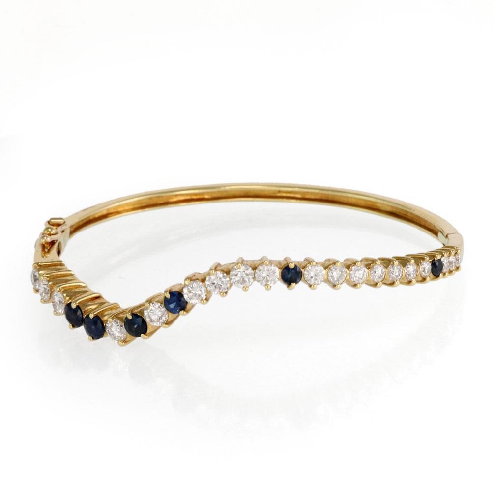 Elegant 3.46ct Diamond Sapphire 18k Yellow Gold Wave Bangle: Elegant 3.46ct Diamond Sapphire 18k Yellow Gold Wave Bangle This exquisite wave-style bangle is a stunning combination of elegance and craftsmanship. Crafted from luxurious 18k yellow gold with a poli