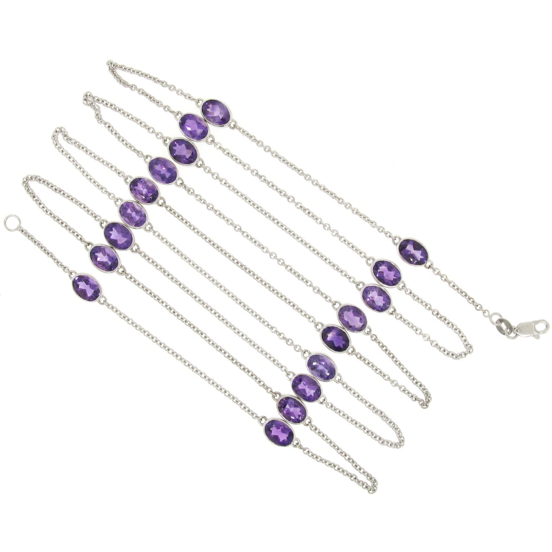 14k White Gold 19.72ctw Oval Amethyst 38 Inch Necklace: 14k White Gold 19.72ctw Oval Amethyst 38 Inch Necklace This stunning necklace features 18 oval cut amethysts, each bezel set and showcasing a rich royal purple color. Crafted from solid 14k white gold