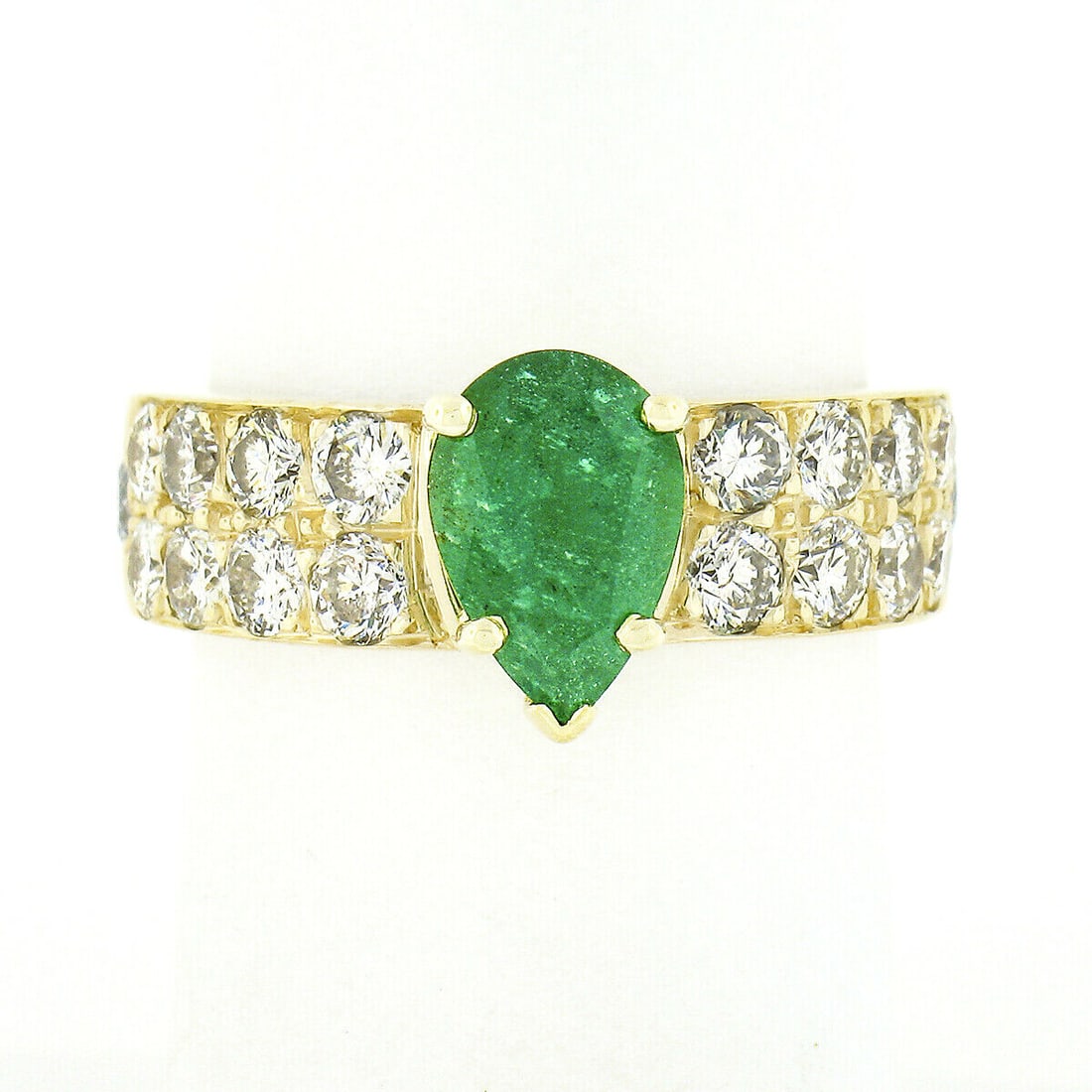 18k Yellow Gold 3.06ct Pear Emerald Diamond Engagement Ring: 18k Yellow Gold 3.06ct Pear Emerald Diamond Engagement Ring This exquisite engagement ring showcases a stunning 3.06ct pear-shaped emerald, elegantly prong set in solid 18k yellow gold. The deep vibra