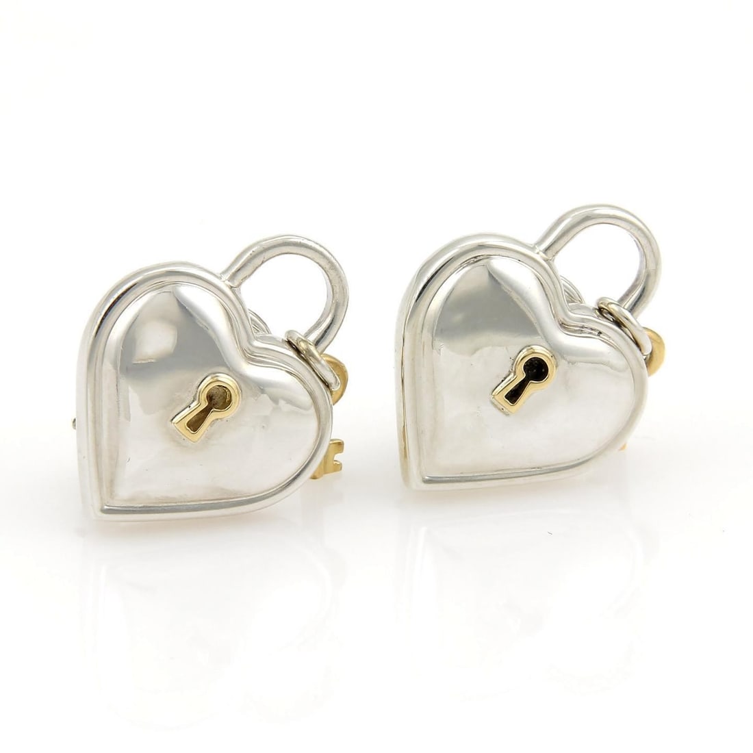 Hearts and Padlock Key Stud Earrings in Sterling and 18k Gold by Tiffany & Co.: Hearts and Padlock Key Stud Earrings in Sterling and 18k Gold by Tiffany & Co. These Tiffany & Co. stud earrings feature heart and padlock key motifs, crafted from sterling silver and 18k yellow gold.