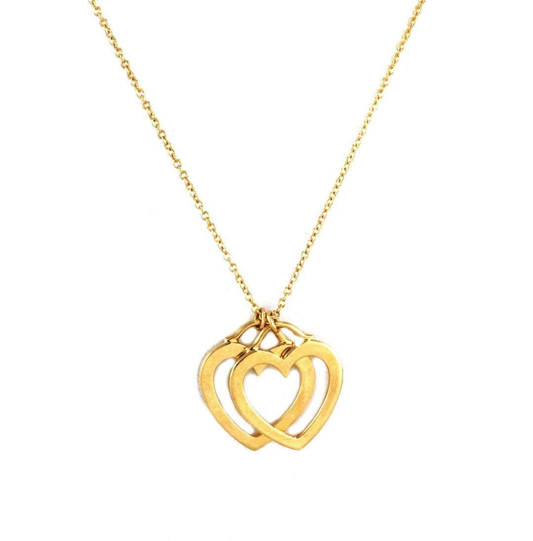 Tiffany & Co. 18k Yellow Gold Double Hearts Pendant with Chain: Tiffany & Co. 18k Yellow Gold Double Hearts Pendant with Chain This exquisite Tiffany & Co. pendant features a stunning double open hearts design crafted from 18k yellow gold, showcasing a polished fi