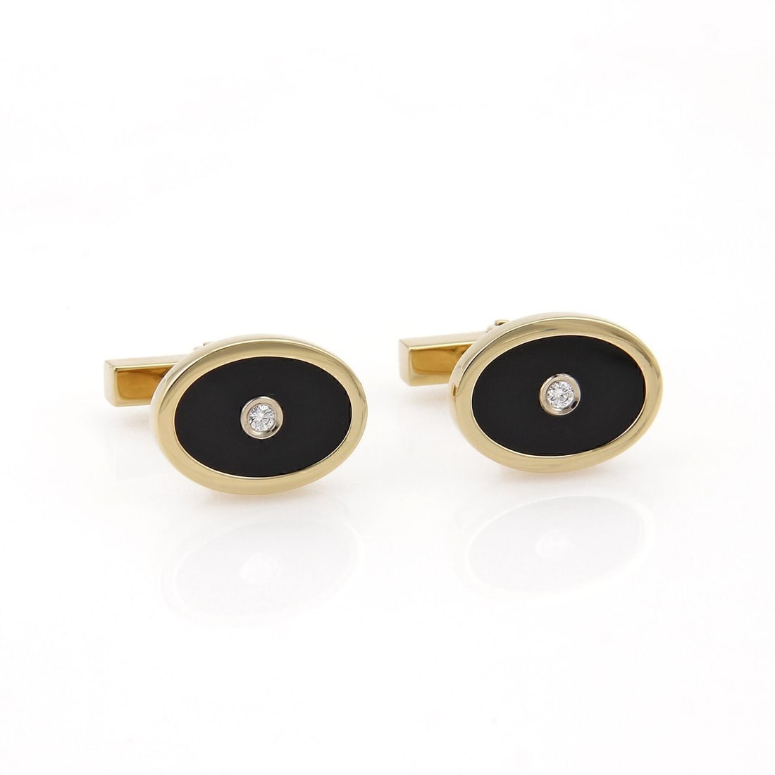 Oval 18k Gold Cufflinks with Diamond and Onyx by Tiffany & Co.: Oval 18k Gold Cufflinks with Diamond and Onyx by Tiffany & Co. These vintage Tiffany & Co. cufflinks feature an oval shape set with diamond and onyx, crafted in 18k yellow gold. Designed for men, they