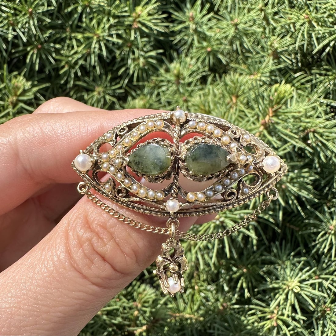 Victorian Revival Brooch in Yellow Gold with Jade and Pearl Dangles: Victorian Revival Brooch in Yellow Gold with Jade and Pearl Dangles This exquisite Vintage Victorian Revival brooch showcases a stunning combination of jade and pearls. Crafted in 13-14K solid yellow