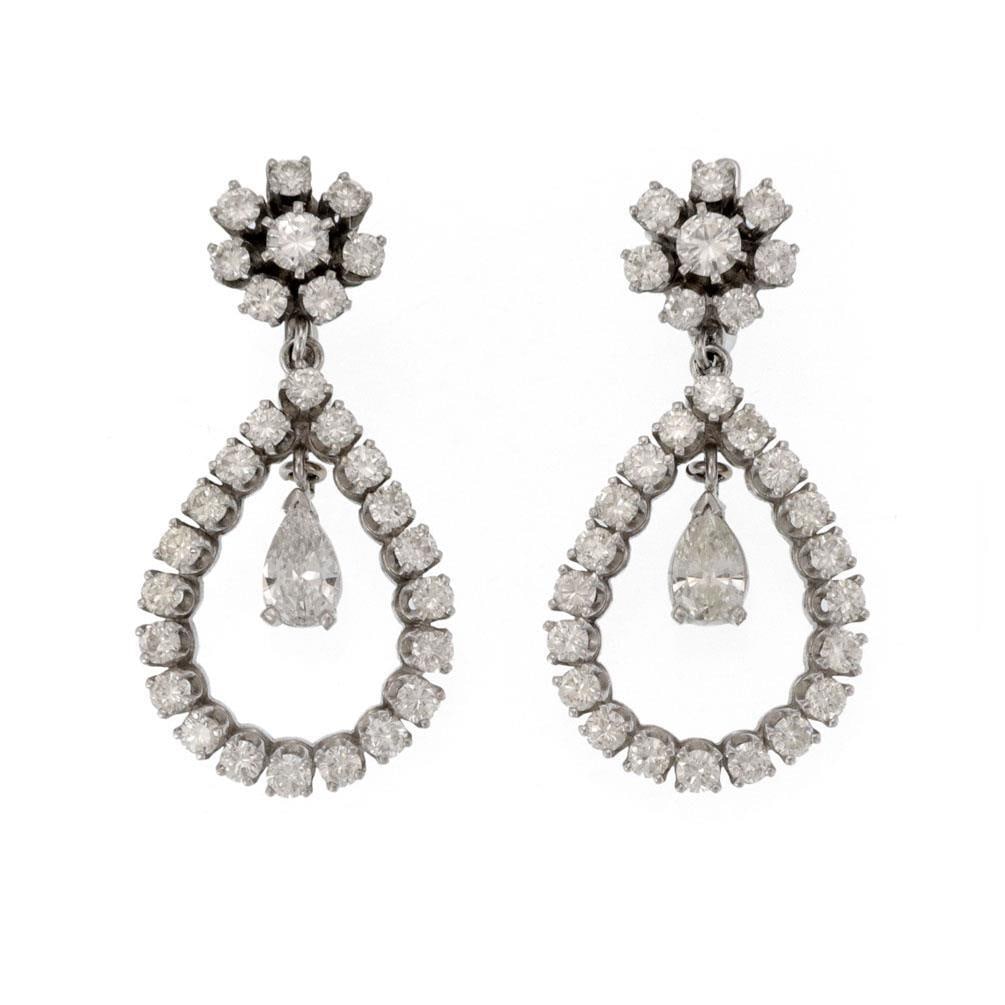 14k White Gold Diamond Drop Earrings Pear Shape Floral Design: 14k White Gold Diamond Drop Earrings Pear Shape Floral Design Elevate your elegance with this stunning pair of Diamond Earrings, meticulously crafted from 14k white gold. The earrings feature a floral