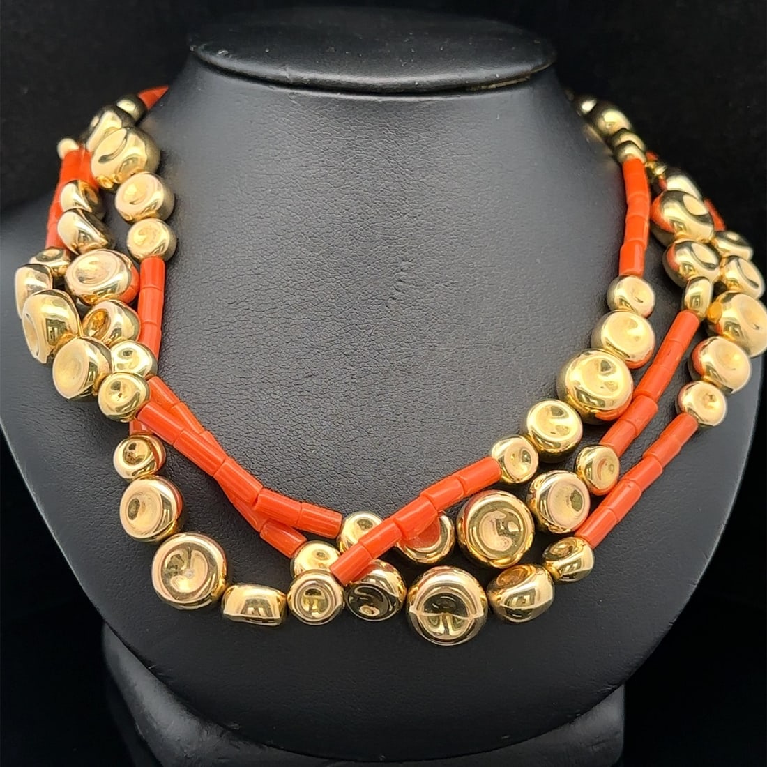 Three Strand Natural Coral Necklace with 18k Yellow Gold Beads and Clasp: Three Strand Natural Coral Necklace with 18k Yellow Gold Beads and Clasp This three-strand necklace features numerous natural orange tube-shaped coral beads, complemented by solid 18k yellow gold bead