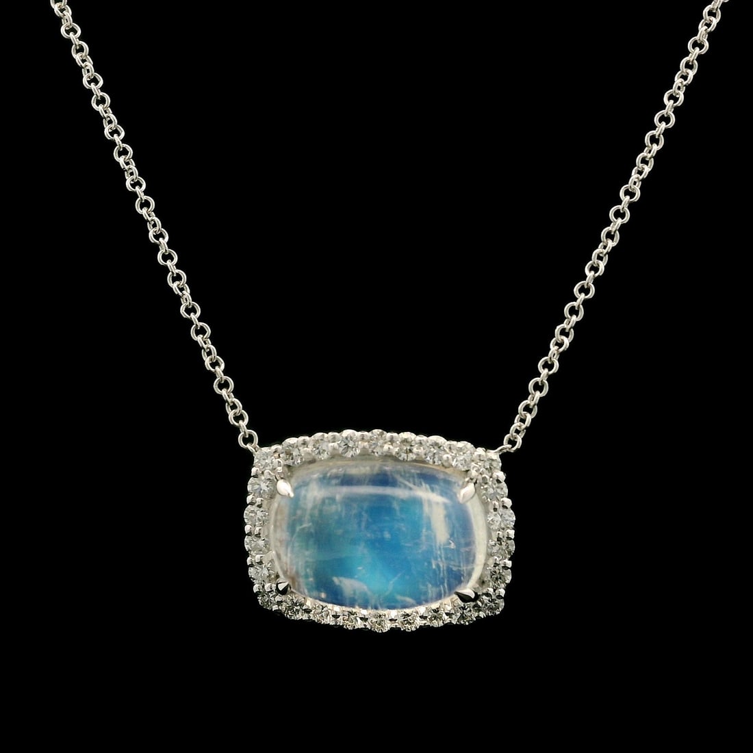 18k White Gold 5.02ctw Blue Moonstone Diamond Halo Pendant Necklace: 18k White Gold 5.02ctw Blue Moonstone Diamond Halo Pendant Necklace This exquisite pendant necklace features a stunning cushion-cut natural blue moonstone, measuring 12.2x9.6mm and weighing 4.66ct. Th