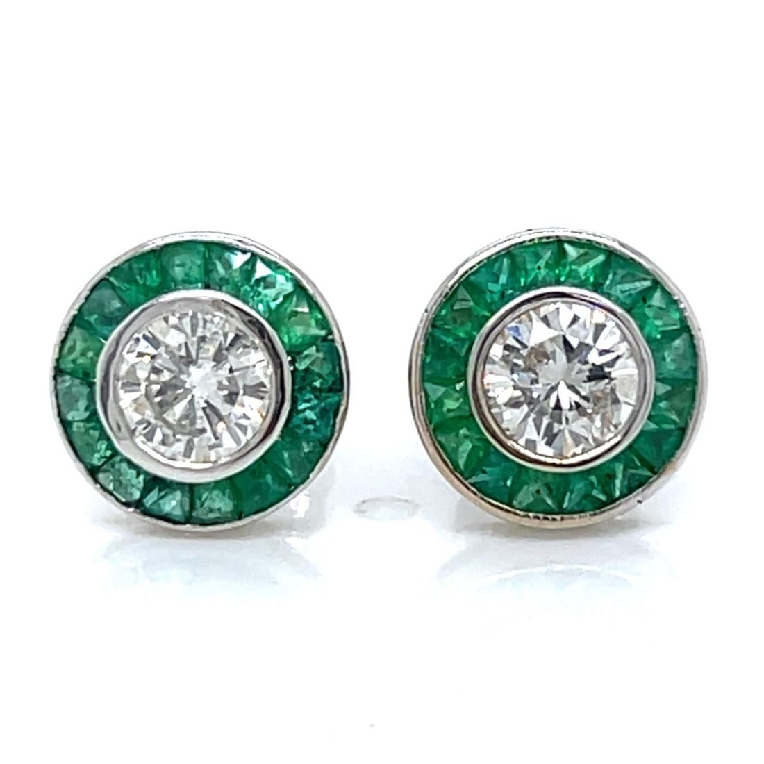 Emerald and Diamond Studs in 18K White Gold 0.92 Ct Emeralds 0.78 Ct Diamonds: Emerald and Diamond Studs in 18K White Gold 0.92 Ct Emeralds 0.78 Ct Diamonds These stud earrings are crafted from 18K white gold and feature two emeralds totaling 0.92 ct. They are accented with two