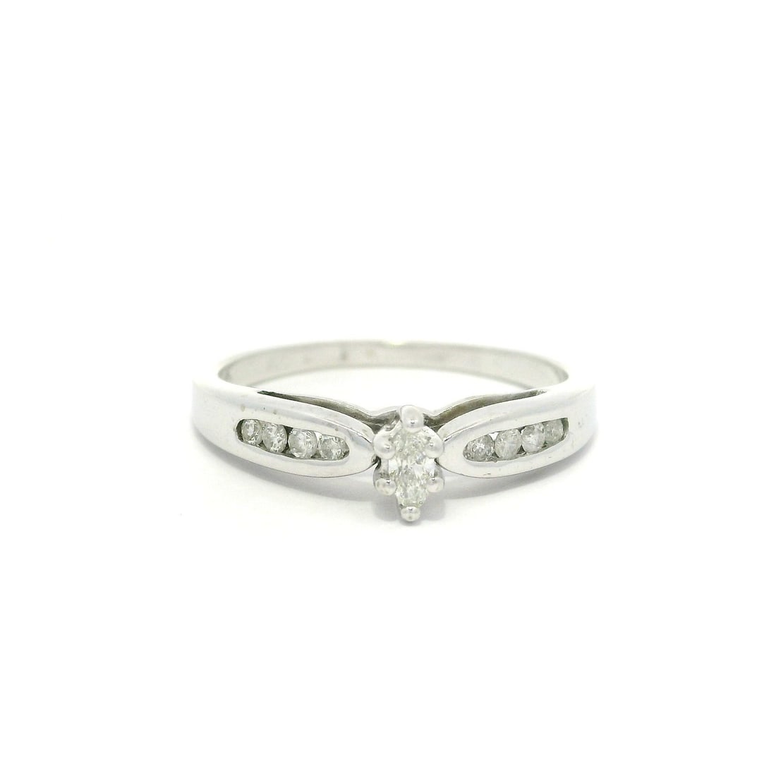 10k White Gold 0.39ctw Marquise & Round Diamond Petite Ring: 10k White Gold 0.39ctw Marquise & Round Diamond Petite Ring This exquisite petite promise ring features a stunning arrangement of diamonds set in solid 10k white gold. At its center, a natural marquis